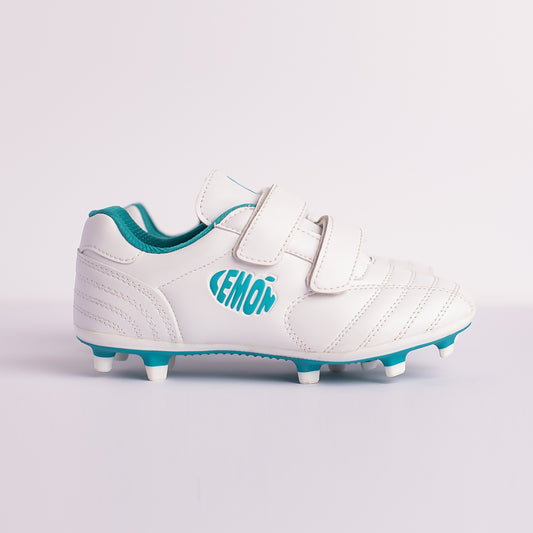 A pair of white football boots with green accents and Velcro straps, featuring a microfiber leather upper and a TPU outsole with studs.